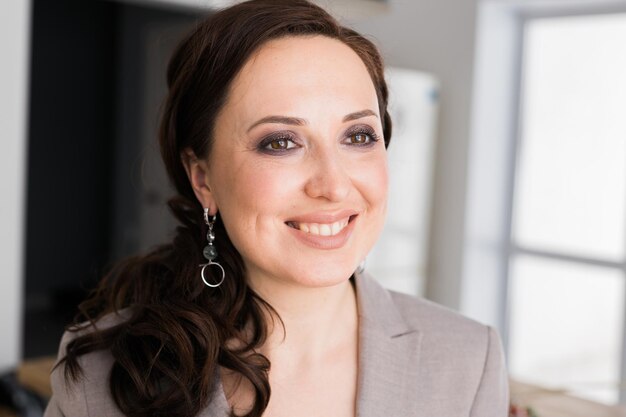 Photo portrait of a female online store business owner looking away and smiling woman doing her small