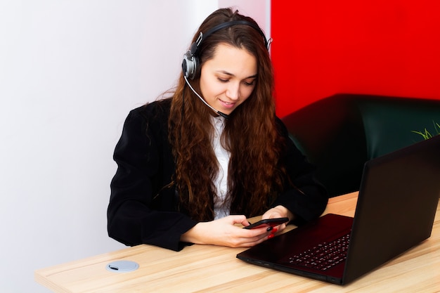 Portrait of a female operator at a computer in an office.