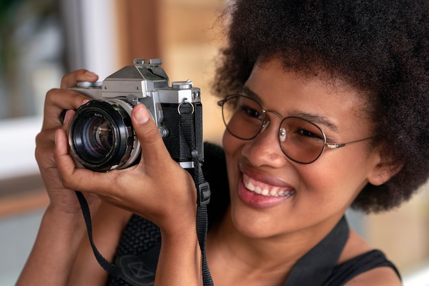 Portrait of female photographer with camera