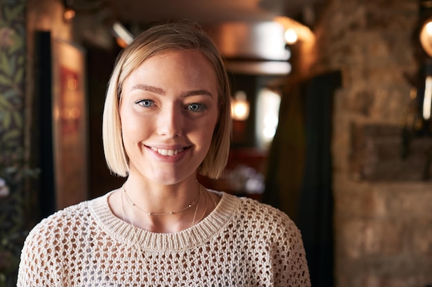 Portrait Of Female Receptionist Working At Hotel Check In