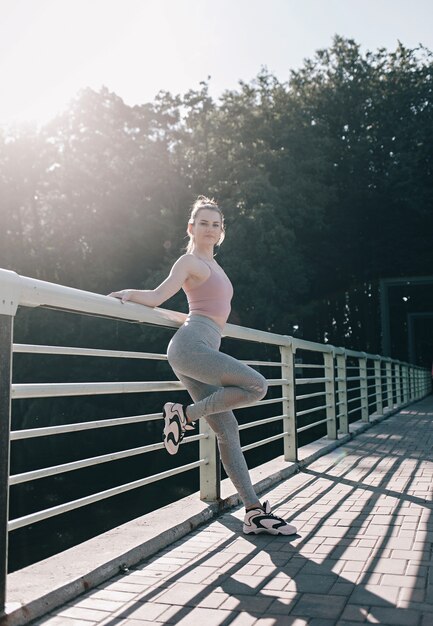 Portrait of a female runner resting after a run in a public park.