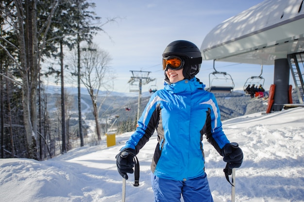 Portrait of female skier on the top of ski slope