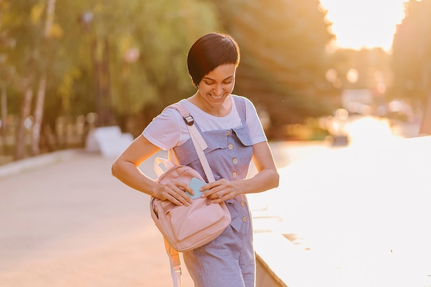 Portrait of female student on a walk with a backpack.