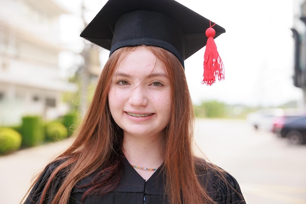 Portrait female student wearing gown and graduating Happy graduate success and celebration Congratulation