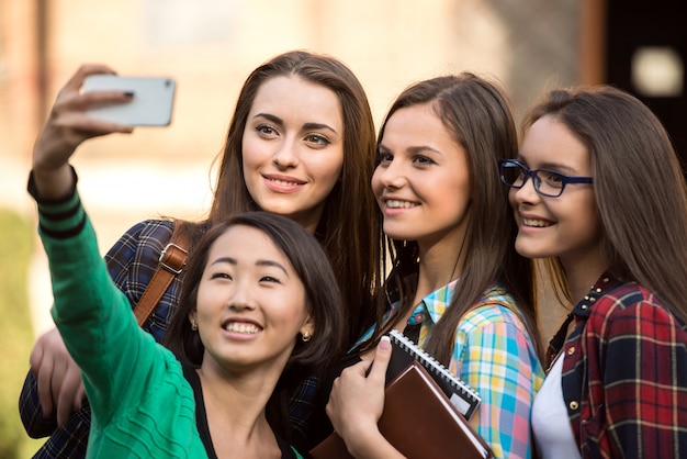 Portrait of female students that are making pictures.