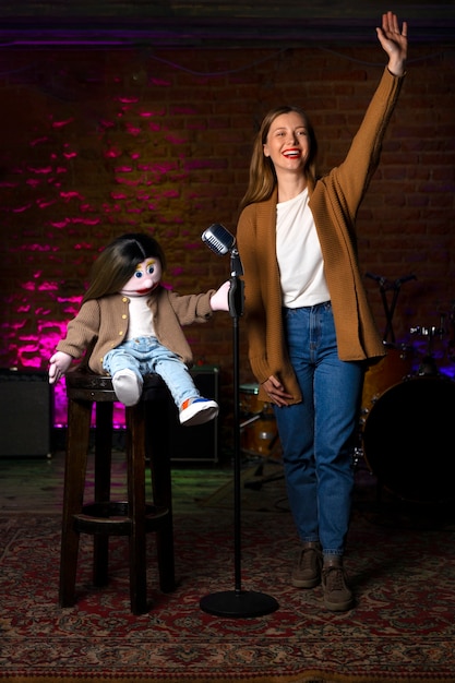 Photo portrait of female ventriloquist during show with puppet