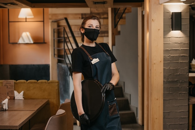 portrait female waitress holding tray