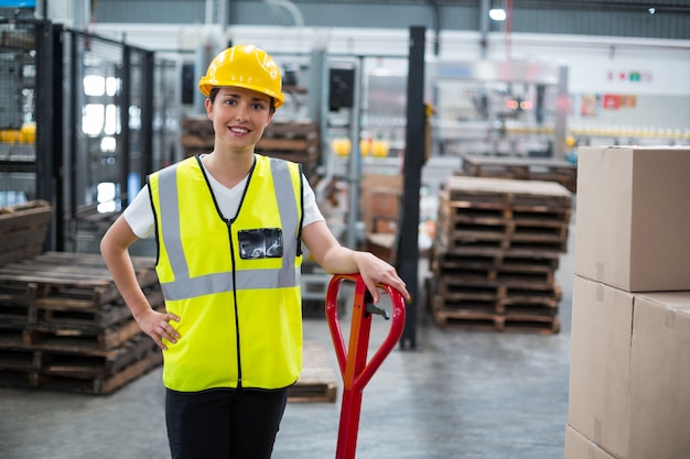 Portrait of female worker standing with hand on hip