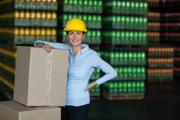 Portrait of female worker standing with hand on hip