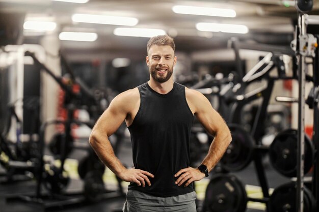 Portrait of a fit muscular sportsman posing in a gym