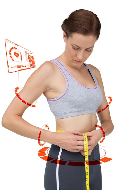 Photo portrait of a fit woman measuring waist against fitness interface