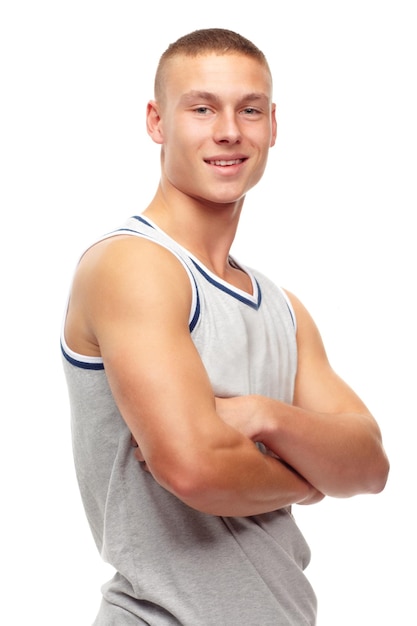 Portrait fitness and smile with man arms folded in studio isolated on white background for sports Exercise health and workout with confident young athlete in tank top for strong muscle training