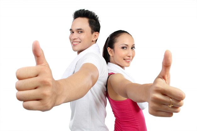 portrait of fitness woman and man showing thumb up