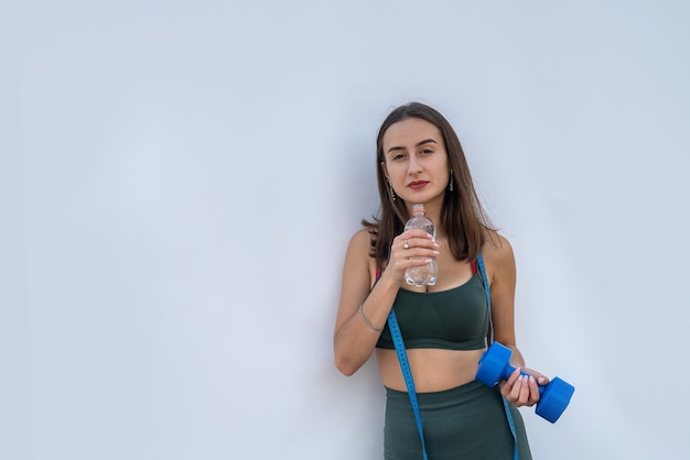 Portrait of fitness woman in sportswear posing isolated