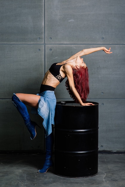 Portrait of fitness woman in studio on cement concrete background