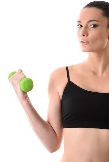 Portrait of fitness woman working out with dumbbell