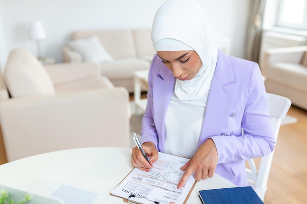 Portrait of focused arabic businesswoman working on computer in office