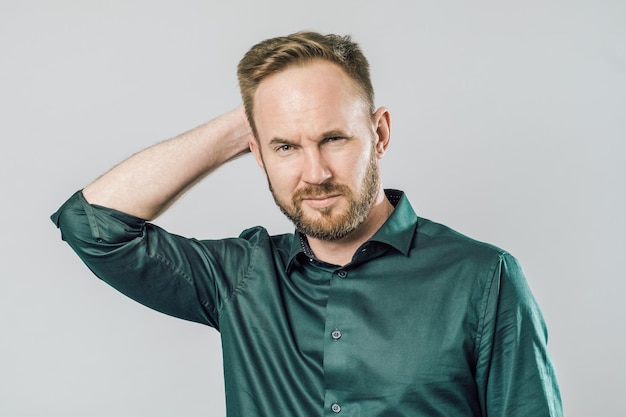 Portrait of focused smart with thoughtful determined expression thinking over grey background