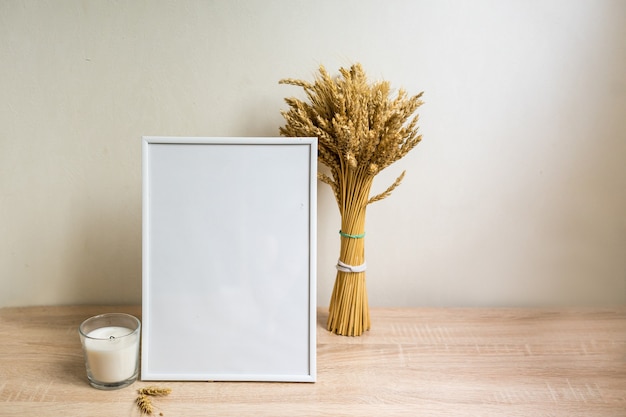 Portrait frame mock up with dried flowers on wooden table. High quality photo