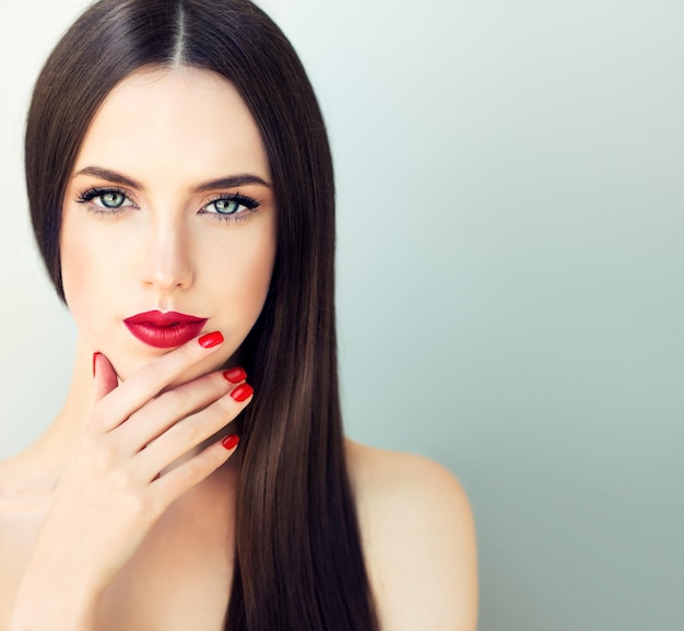 Portrait Freely lying long black hair bright red on the lips and nails magnetic blue eyes Fashion