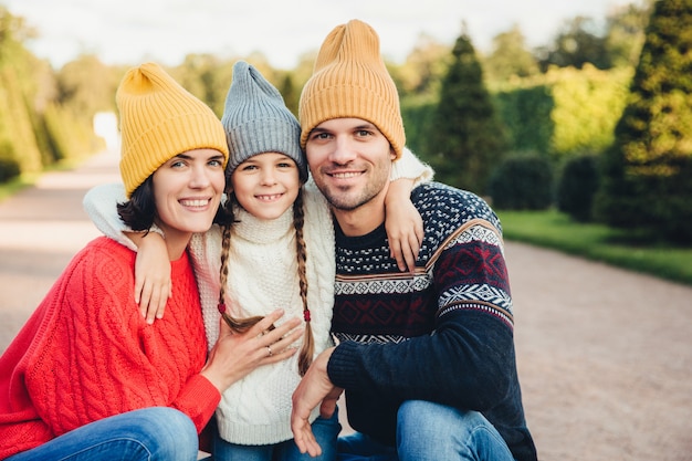 Portrait of friendly affectionate family hug each other