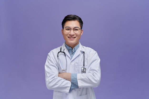 Portrait of friendly Asian doctor man over purple smiling to camera