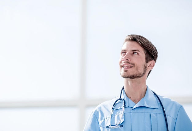 Portrait of a friendly doctor in blue uniform