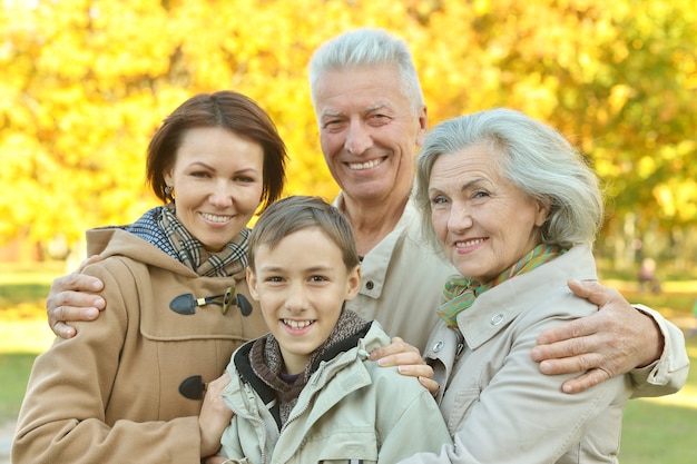 Portrait of friendly family together in autumn park