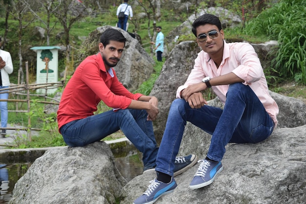 Photo portrait of friends sitting on rocks