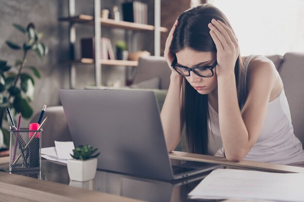 Portrait of frustrated exhausted girl manager touch hands head feel migraine