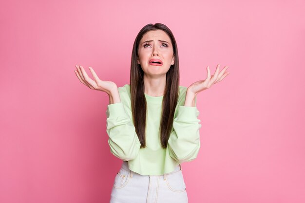 Portrait of frustrated lonely girl look copyspace hold hands feel despair cry wear pullover isolated over pastel color background