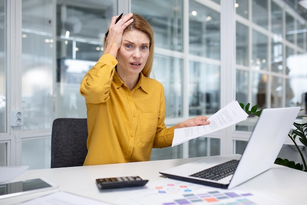 Portrait of frustrated and upset female financier inside office at workplace business woman looking