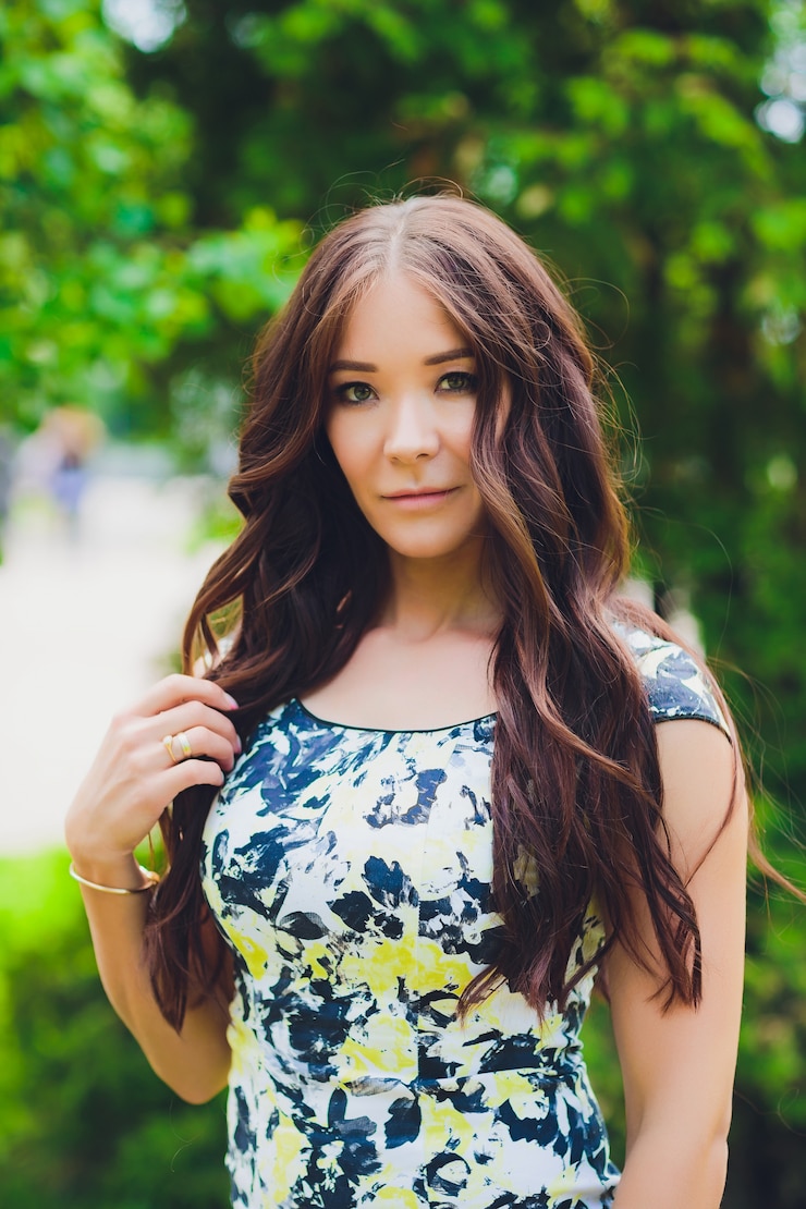 Photo portrait in full growth, young beautiful dark blonde woman in blue dress on street
