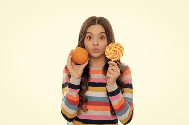 Portrait of fun funny teen girl with orange lollipop vitamin and dieting child dental care