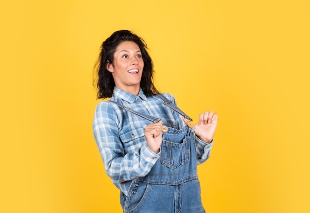 Portrait of funny caucasian female with brunette hair just having fun girl feeling happiness happy cheerful young woman wearing her checkered shirt rejoicing at positive news