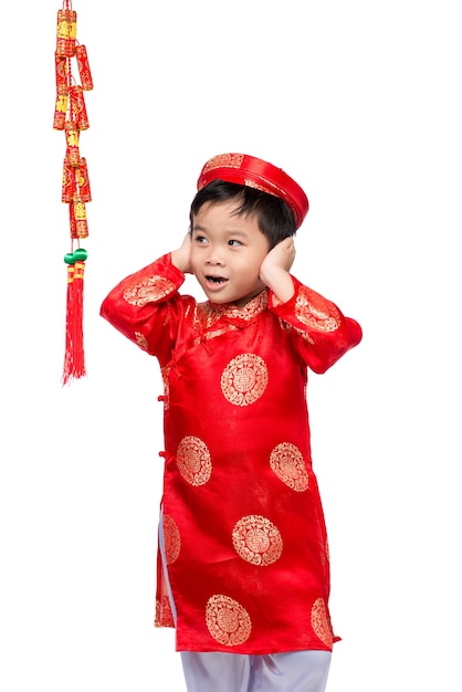 Portrait of a funny and exciting Vietnamese boy with firecrackers. Asian Kid Celebrating New Year