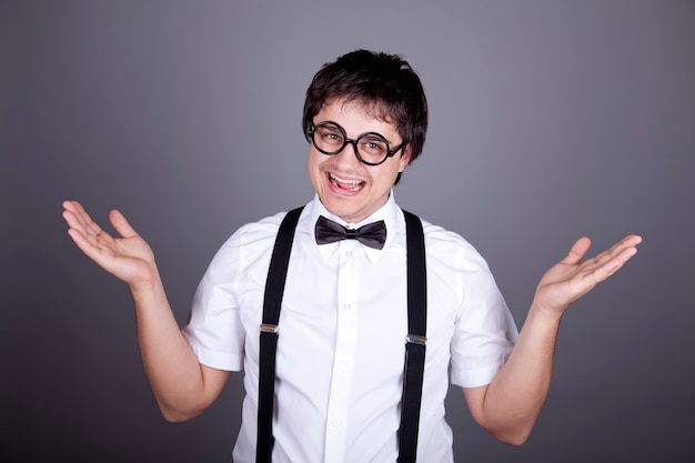 Portrait of funny fashion men in suspender with bow tie and glasses.