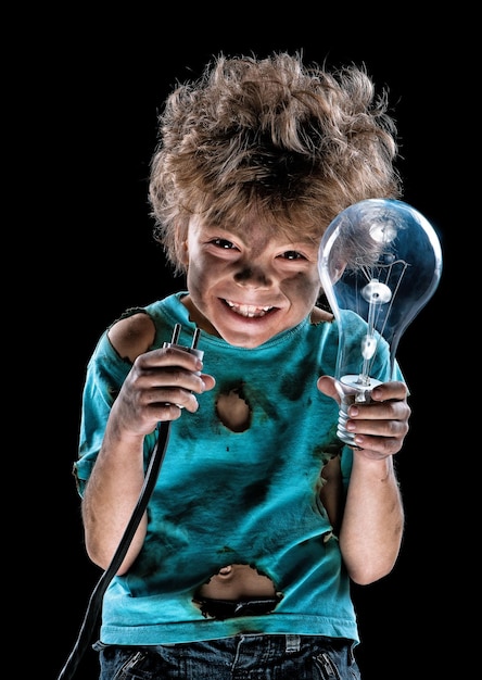 Portrait of funny little electrician with lightbulb over black background