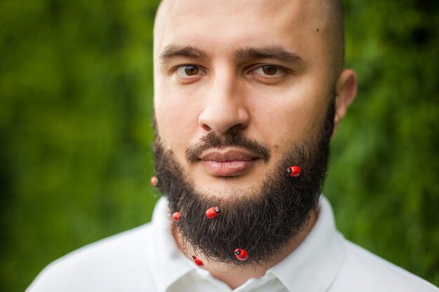 Portrait of funny man with decoration in his beard