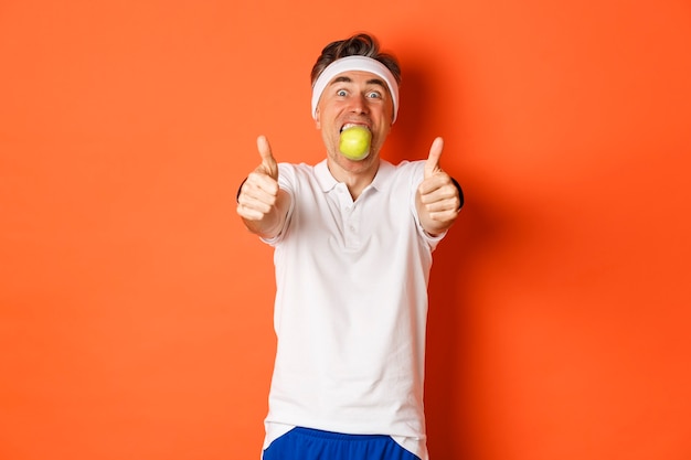 Portrait of funny middle aged guy in fitness clothing