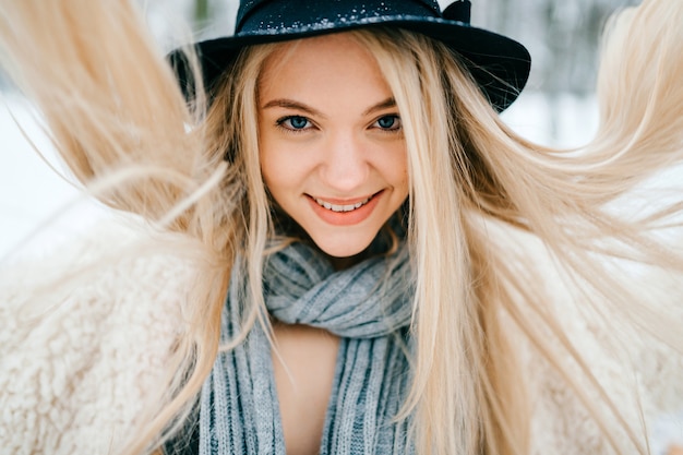 Portrait of funny pretty stylish blonde girl with flying hair