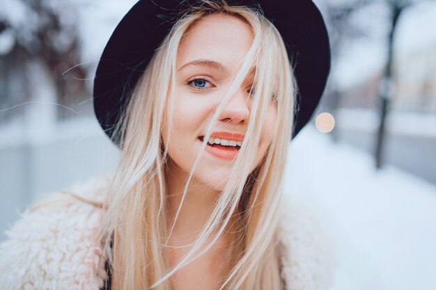 Portrait of funny smiling stylish blonde girl in hat