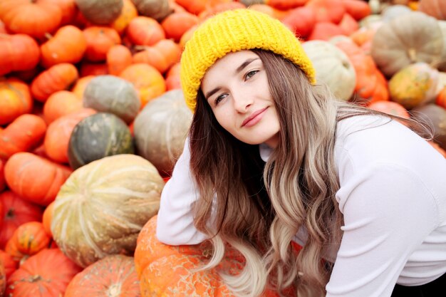 Portrait of a funny young girl in the autumn weather in warm clothes and hat