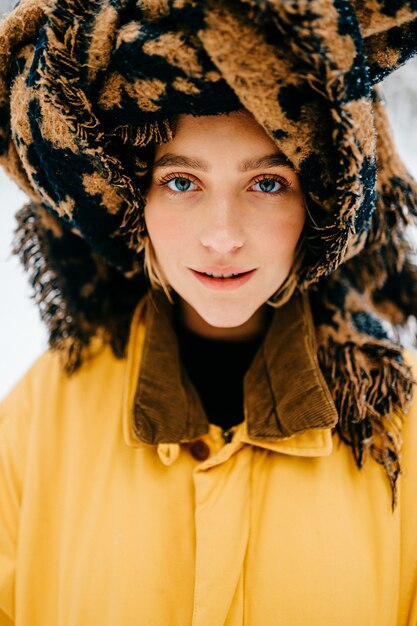 Portrait of funny young hipster girl with a turban of the scarf posing