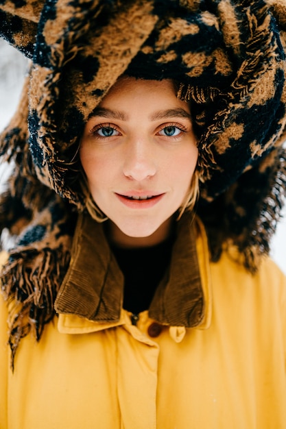 Portrait of funny young hipster girl with a turban of the scarf posing