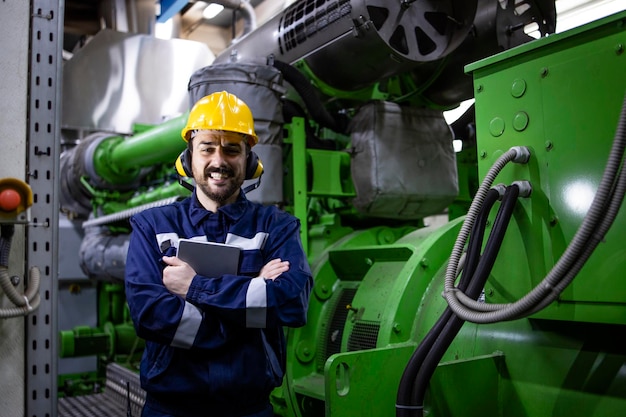 Portrait of gas generator serviceman standing in power plant
