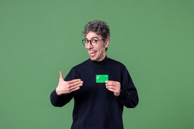 Photo portrait of genius man holding credit card in studio