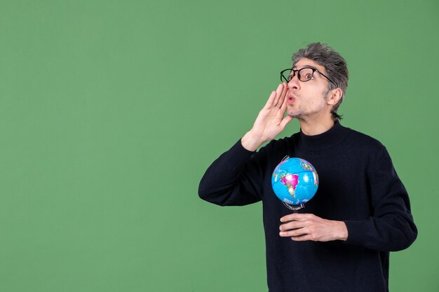 portrait of genius man holding earth globe green background space air sea teacher planet nature school