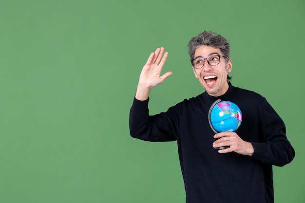 portrait of genius man holding earth globe green background space nature teacher sea air school