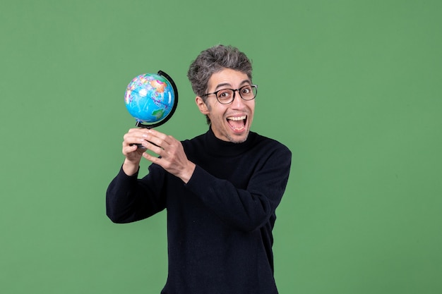 portrait of genius man holding earth globe studio shot green background sea nature space teacher air planets